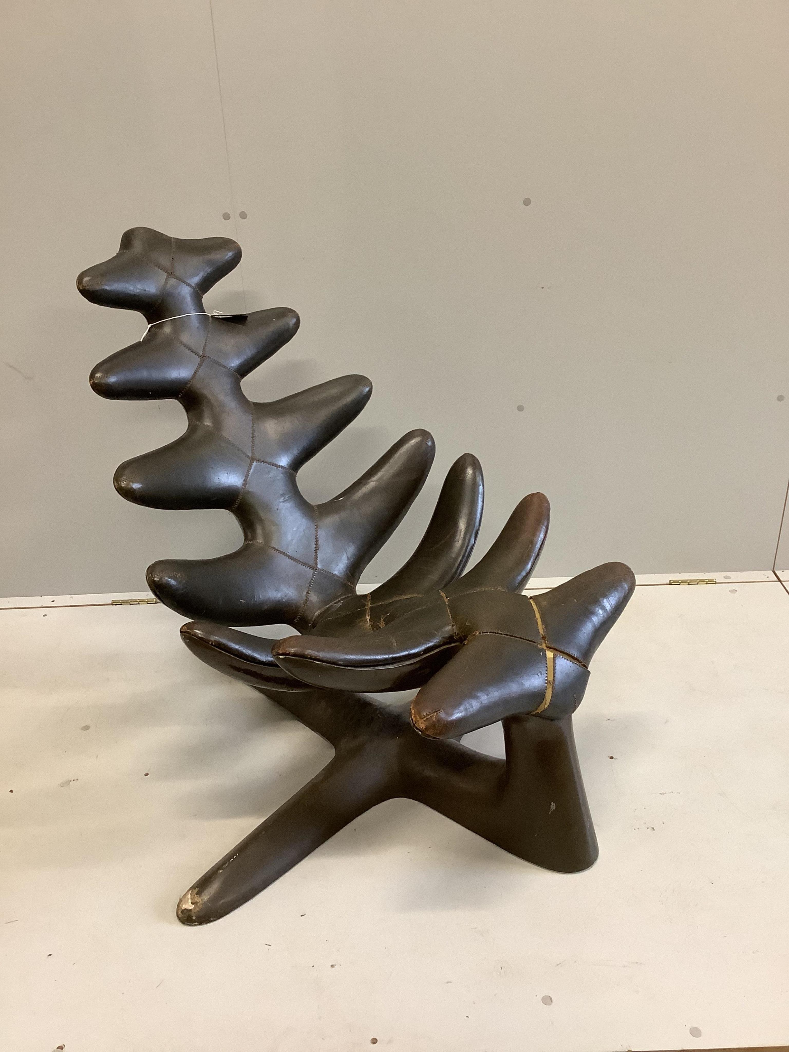 A mid century modernist reclining leather chair, width 100cm, depth 100cm, height 94cm